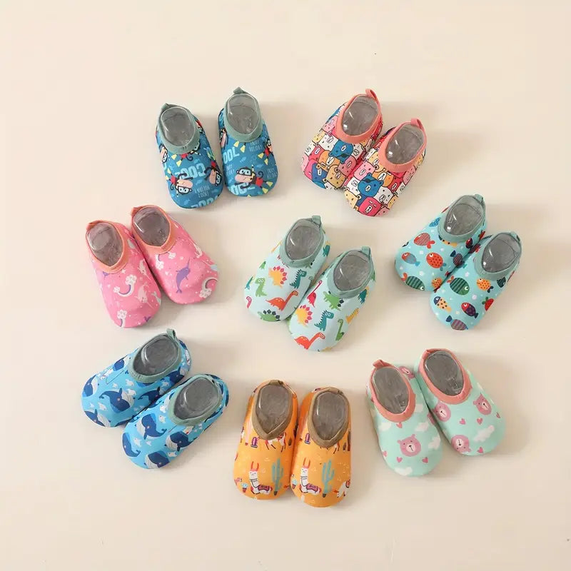 Set of colorful baby shoes with various patterns on a light background