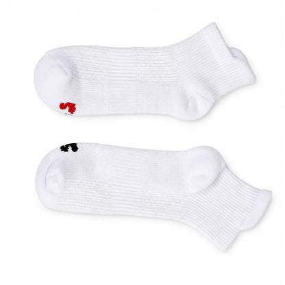 Pair of white ankle compression socks laid flat with red and black size markers