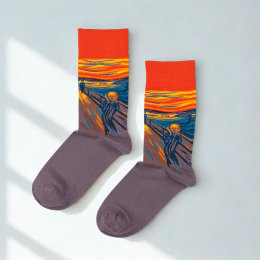 Pair of The Scream art crew socks with orange cuffs and purple feet in natural window light