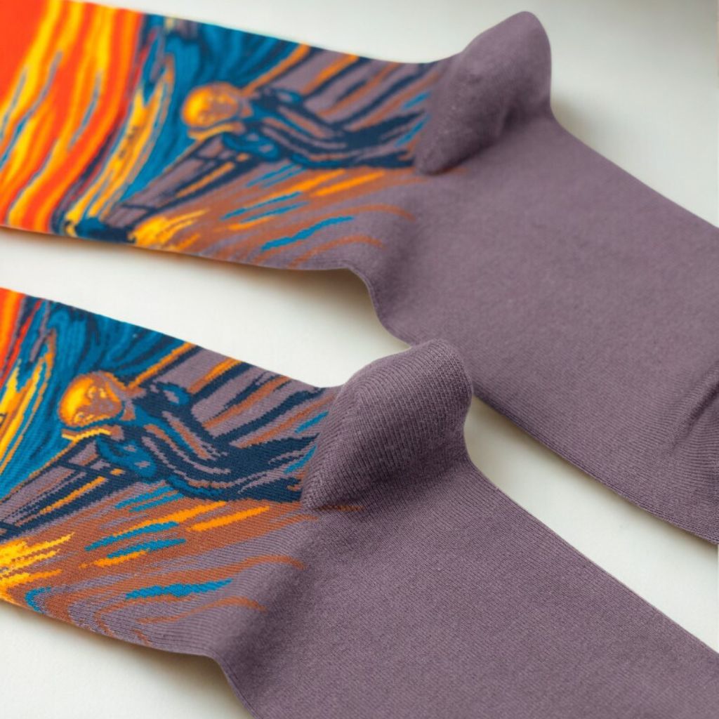 The Scream crew socks turned over to show their purple soles, heels and knitted side artwork