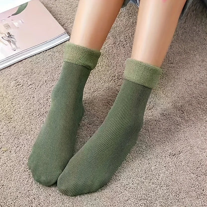 Green fleece-lined ankle socks worn on carpet with soft rolled cuffs