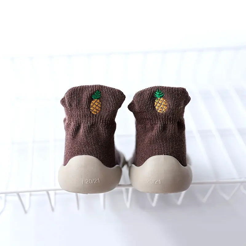 Grey Mini Walker sock shoes with embroidered pineapple designs and flexible grey soles