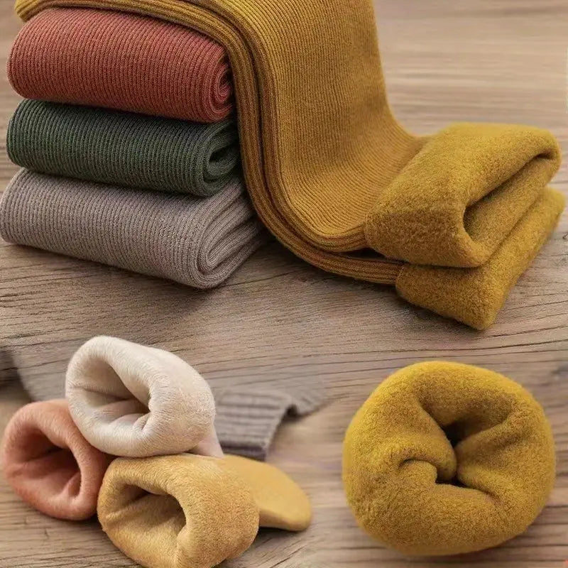 Close-up of thick fleece lining inside warm indoor socks in assorted neutral and earthy colours
