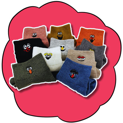 Ten folded crew socks in assorted colours showing their embroidered character faces