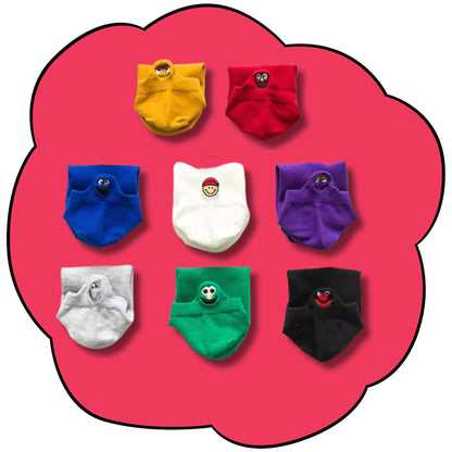 Eight folded character ankle socks arranged in rows on a bright pink flower background