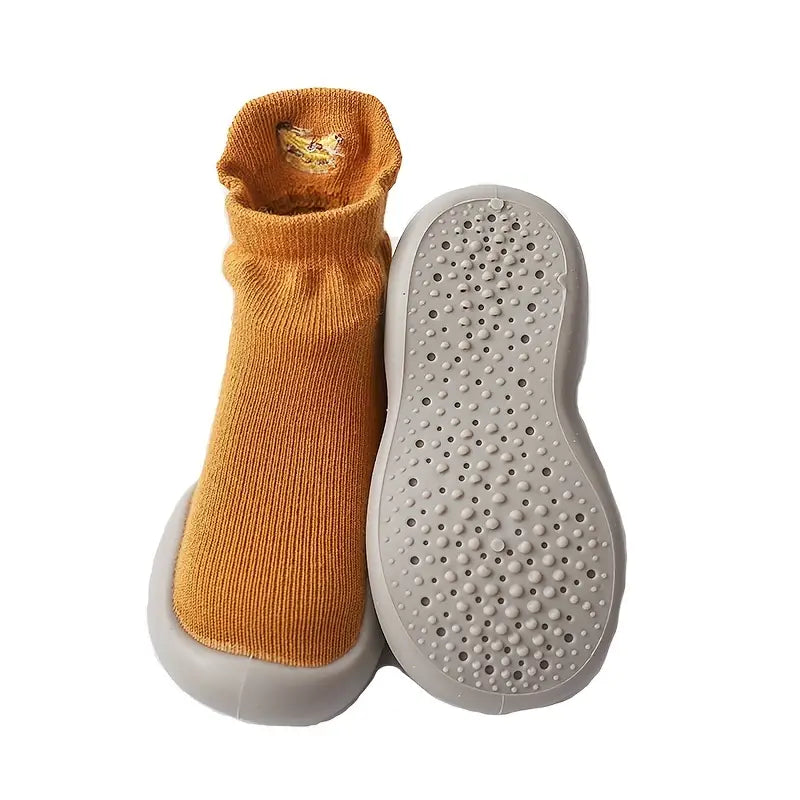 Mustard Mini Walker sock shoe shown beside its textured non-slip rubber sole