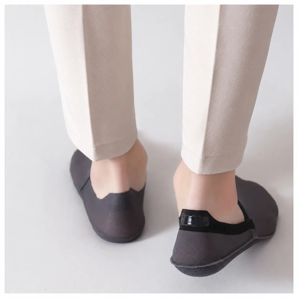 Black invisible socks viewed from the back to show the low-cut heel and secure grip strip
