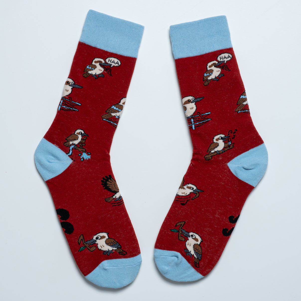 Pair of red kookaburra crew socks with light blue cuffs, heels and toes arranged heel to heel