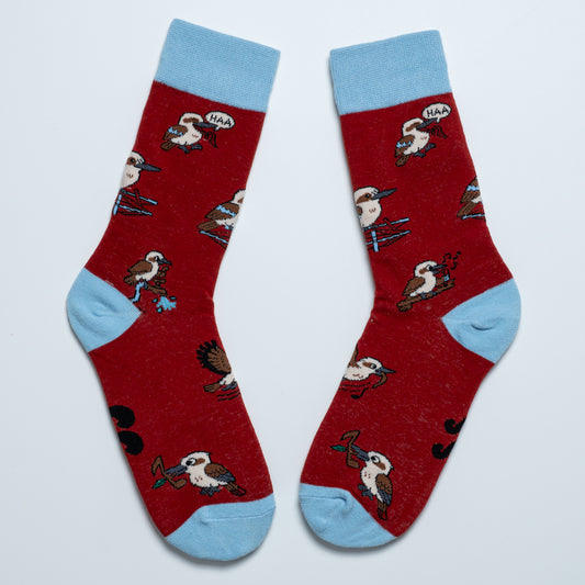 Pair of red kookaburra crew socks with light blue cuffs, heels and toes arranged heel to heel
