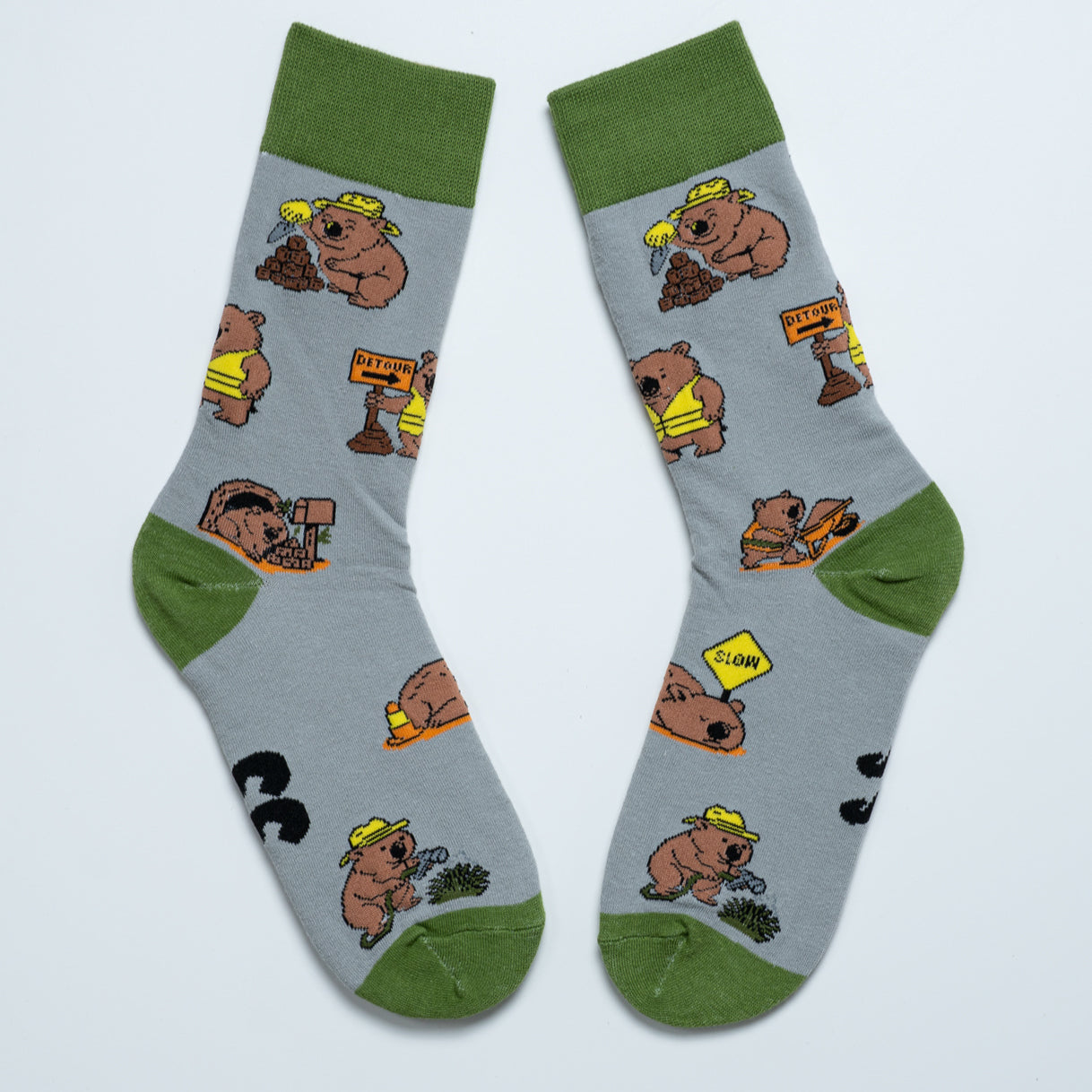 Pair of grey Wombat crew socks with green cuffs, heels and toes arranged heel to heel