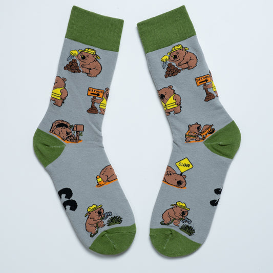 Pair of grey Wombat crew socks with green cuffs, heels and toes arranged heel to heel