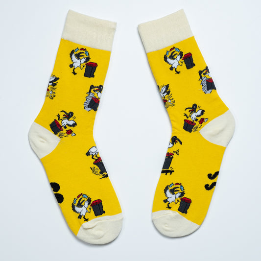 Yellow Australian ibis crew socks laid diagonally with red cuffs, heels and toes