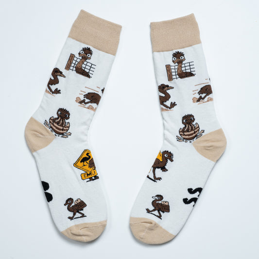 Pair of white emu socks laid side by side with playful emu scenes and an Australian road sign