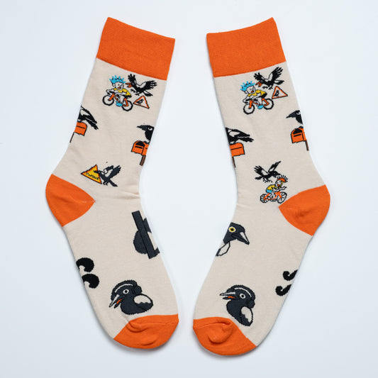 Pair of cream magpie crew socks with orange cuffs, heels and toes arranged heel to heel