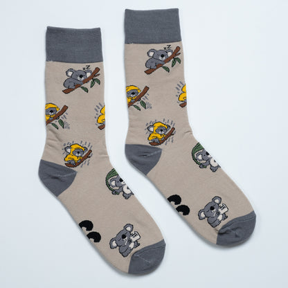 Pair of beige koala socks laid side by side with sleeping and raincoat koala illustrations