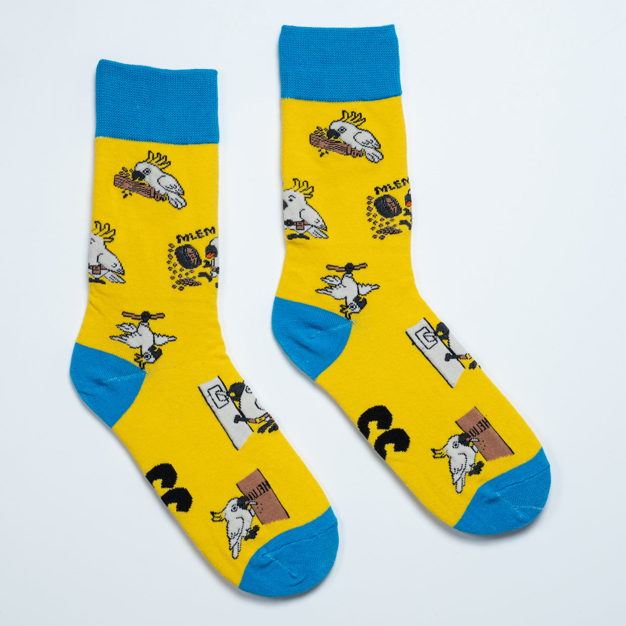 Yellow cockatoo crew socks with blue cuffs, heels and toes featuring playful Australian bird scenes