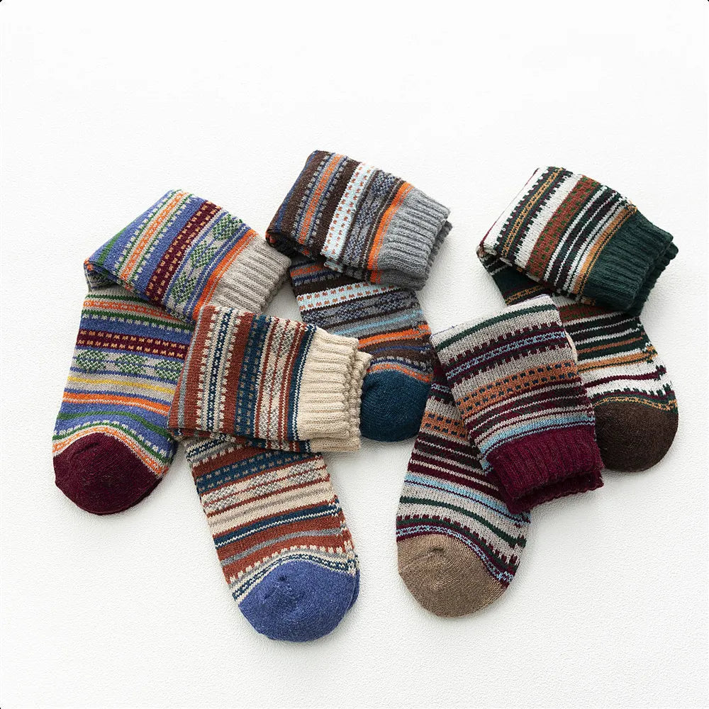 Five Toasty Threads wool socks folded and rolled to show their patterned knit and coloured toes