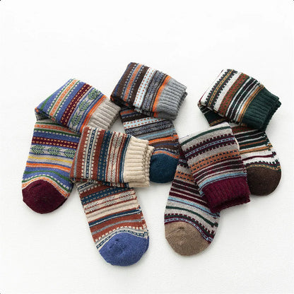 Five Toasty Threads wool socks folded and rolled to show their patterned knit and coloured toes