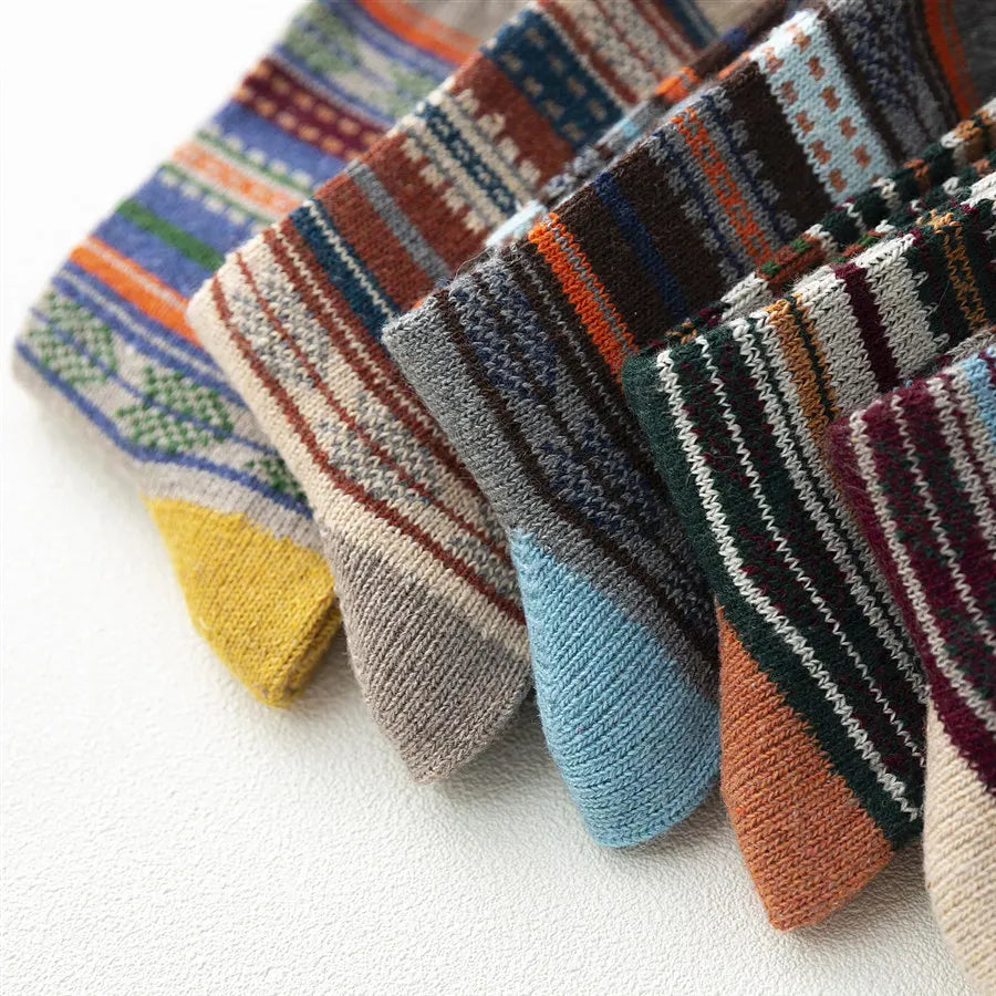 Close-up of five wool blend socks showing their assorted coloured toes and striped patterns