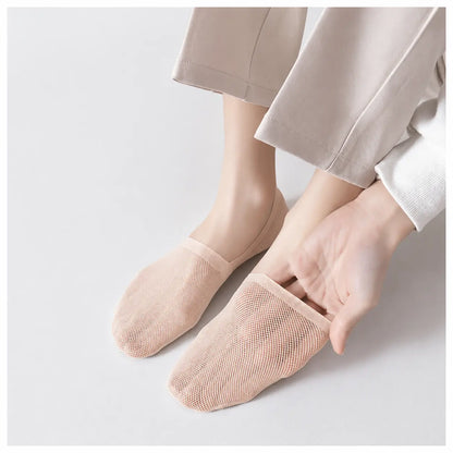 Nude invisible sock pulled at the heel to demonstrate its stretch and secure fit