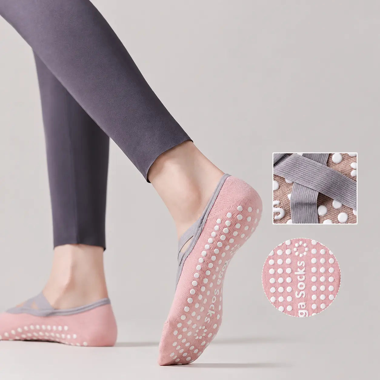 Pink Pilates grip socks worn to show the white non-slip sole and grey crossover straps