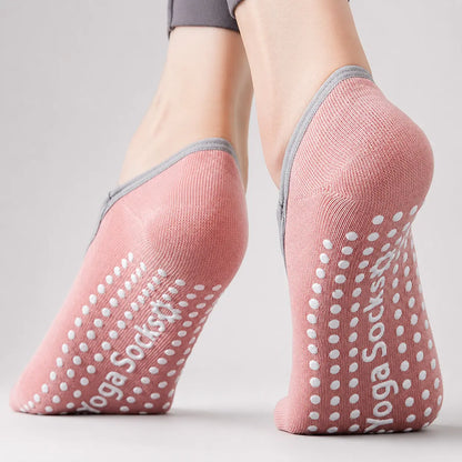 Close-up of pink Pilates grip socks showing the heel coverage and non-slip soles