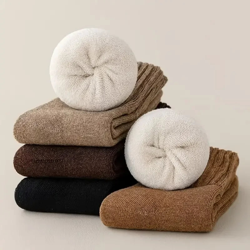 Folded cashmere wool socks in black, brown, beige and cream with rolled socks showing their plush thickness