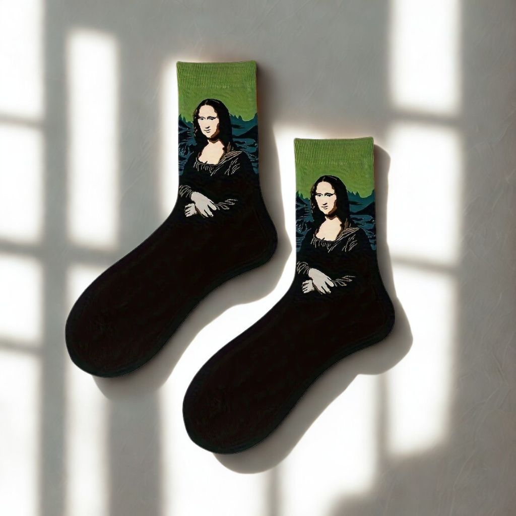 Pair of black Mona Lisa crew socks with green cuffs displayed in natural window light