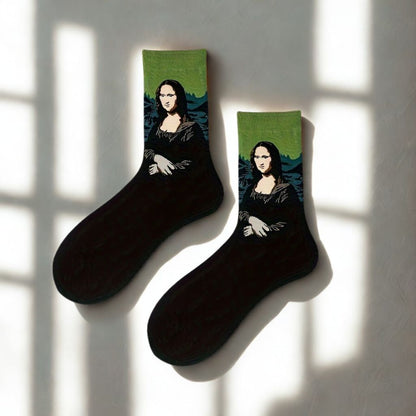 Pair of black Mona Lisa crew socks with green cuffs displayed in natural window light
