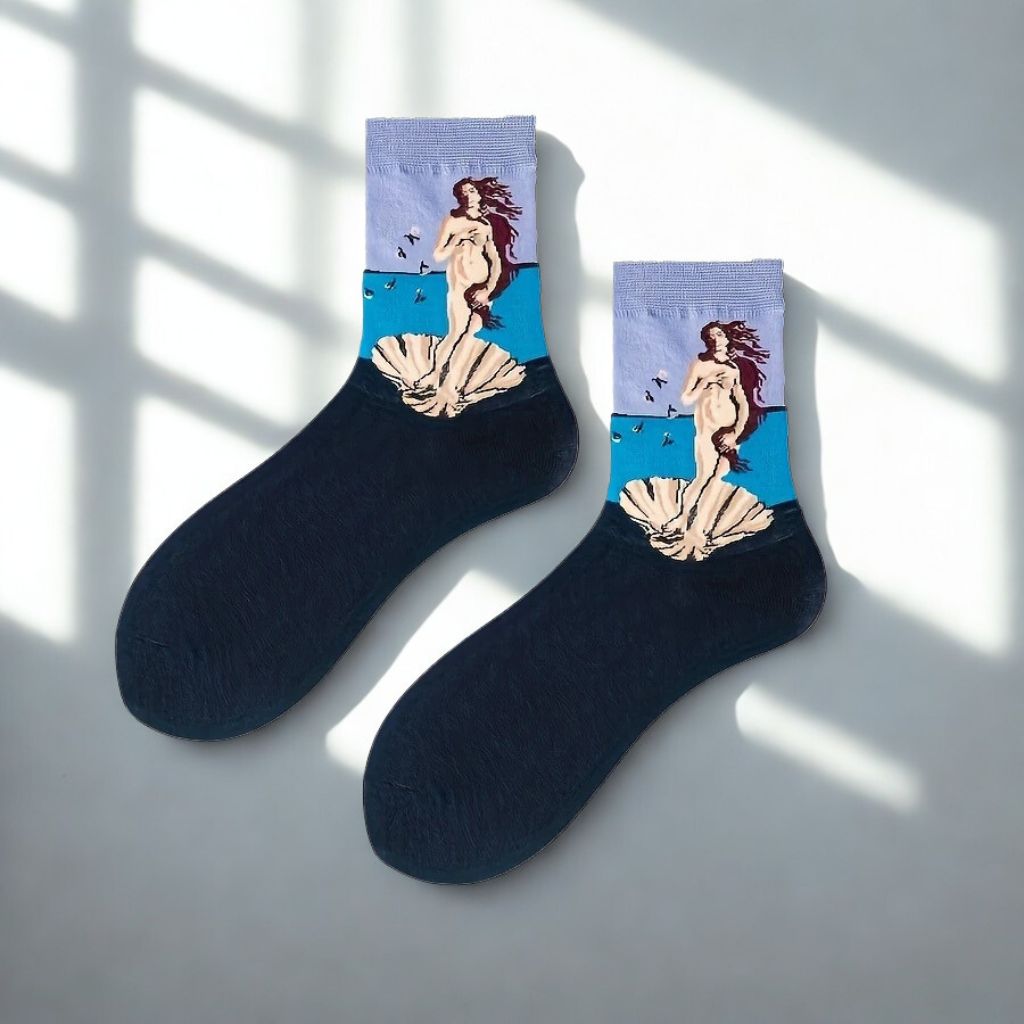 Pair of Birth of Venus art crew socks with lavender cuffs and navy feet in natural window light
