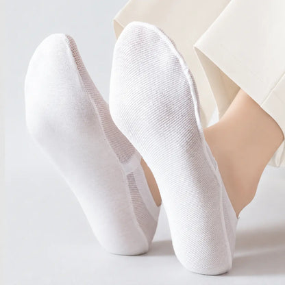 White invisible socks shown from the soles to highlight full foot coverage and lightweight knit
