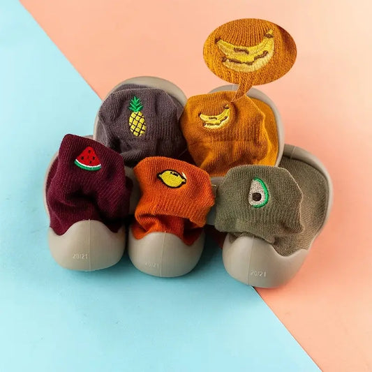 Five Mini Walker sock shoe styles with watermelon, avocado, lemon, banana and pineapple designs
