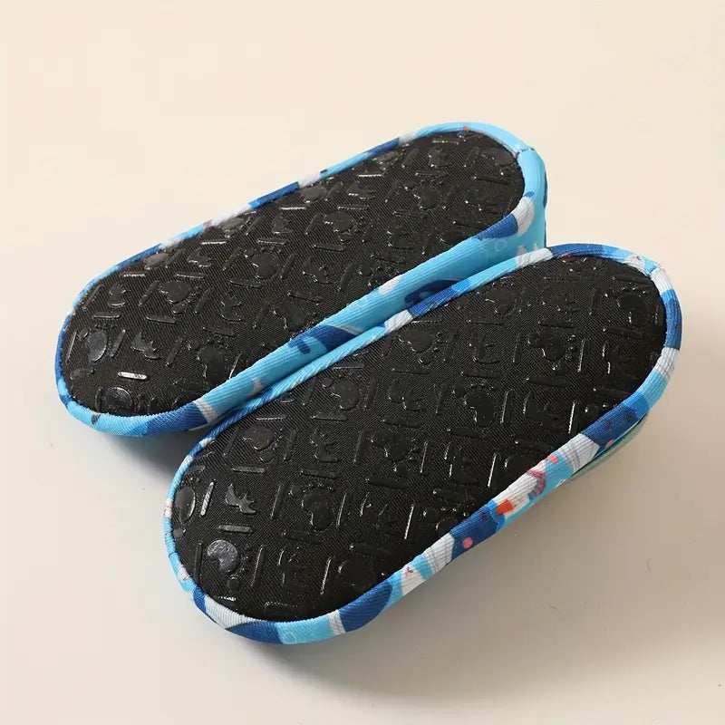 Pair of black shoe insoles with blue and white patterned edges on a beige background