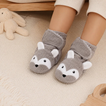 Baby wearing grey fox non-slip bootie socks on a soft indoor rug