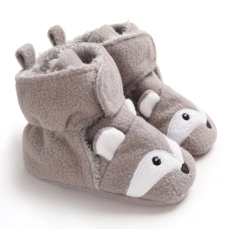 Pair of grey plush fox baby bootie socks on a white background