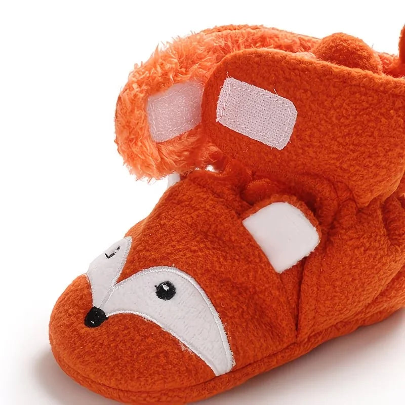 Close-up of the adjustable fastening and plush lining on an orange fox baby bootie sock