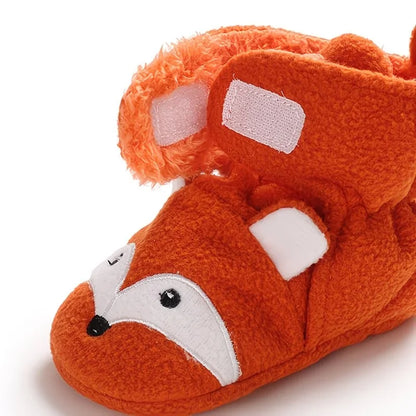 Close-up of the adjustable fastening and plush lining on an orange fox baby bootie sock