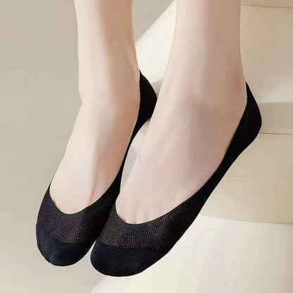 Black BareLite ultra low-cut footie socks worn on both feet