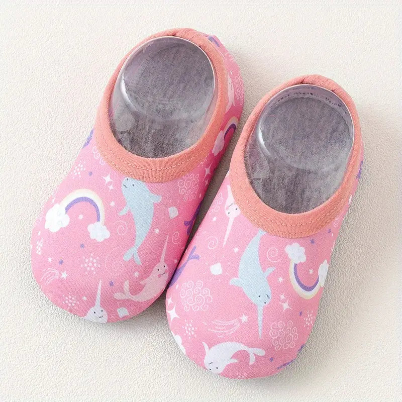 Pair of pink children's shoes with animal prints on a light background