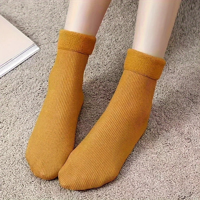 Mustard fleece-lined ankle socks worn on carpet with plush rolled cuffs
