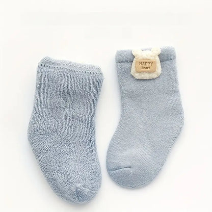 Light blue baby socks shown from the outside and inside to highlight the soft terry lining