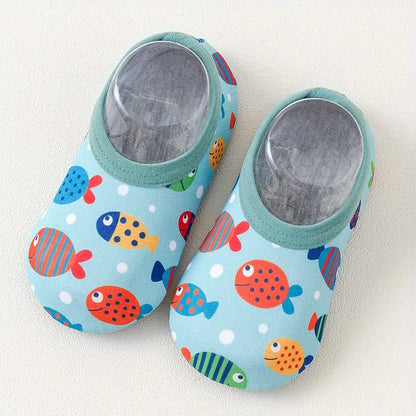 Pair of children's slippers with fish pattern on a light background