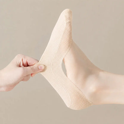 Nude BareLite footie sock pulled at the heel to demonstrate its lightweight stretch