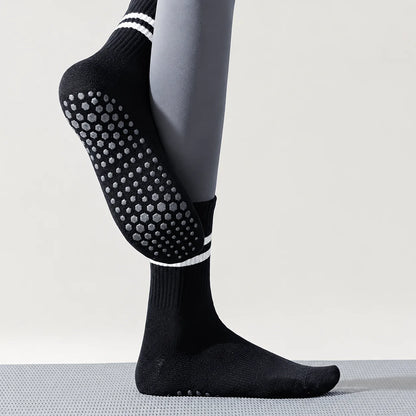 Black Studio Crew Grip Socks worn to show the full non-slip sole and striped crew cuff