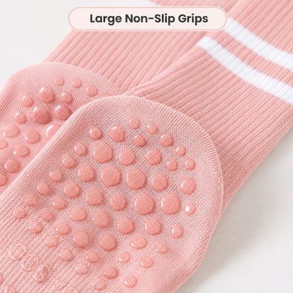 Close-up of the large non-slip grip dots on pink Studio Crew Grip Socks