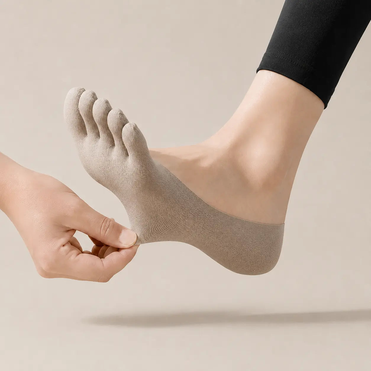 Sand beige BareToe five-toe invisible sock stretched at the heel to show its flexible fit
