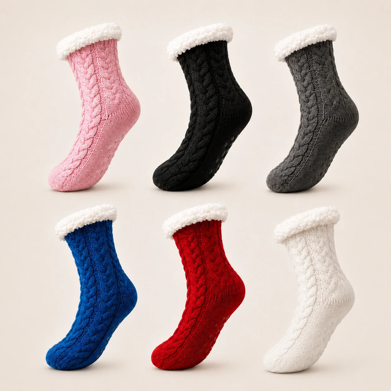 Six cable-knit slipper socks with white sherpa trim, shown in pink, black, gray, blue, red, and white on a light beige background.