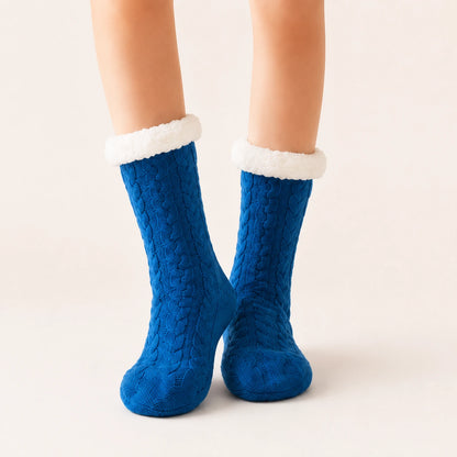 Teal blue sherpa-lined slipper socks worn on feet