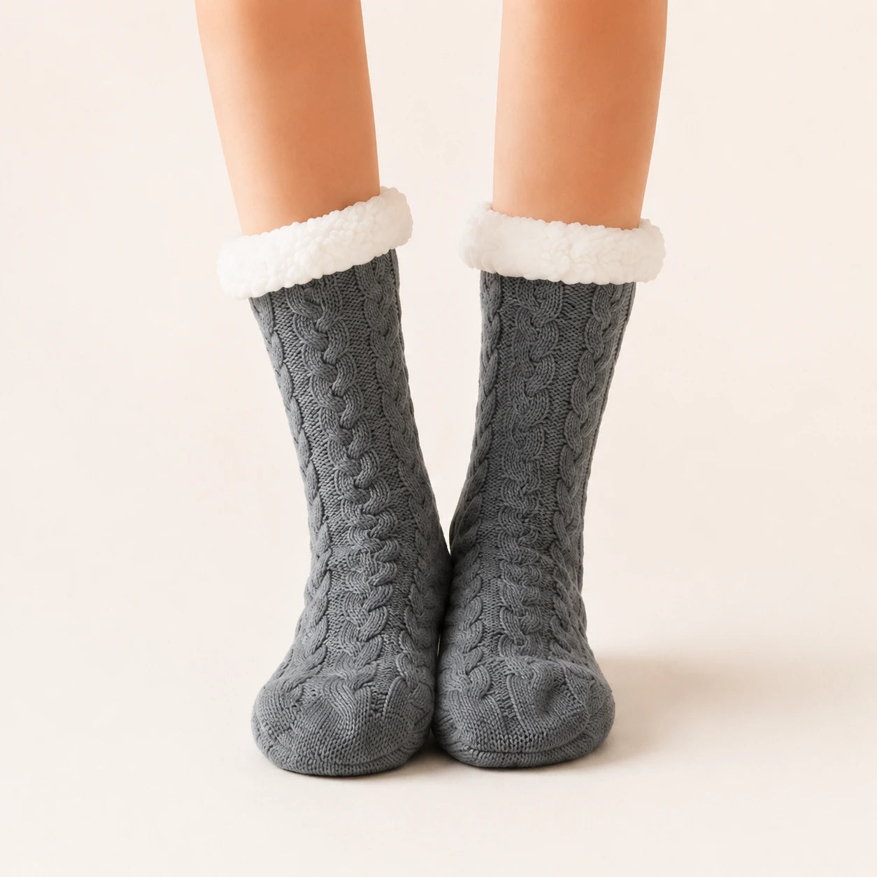 Dark grey sherpa-lined slipper socks worn on feet