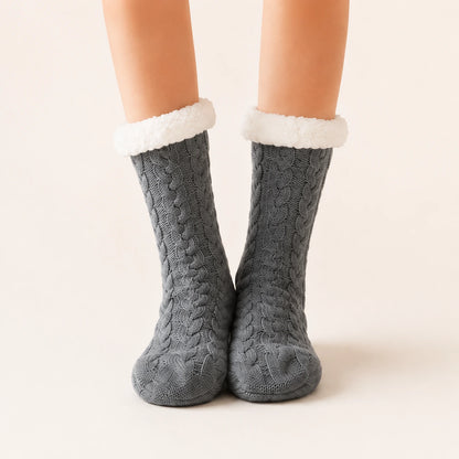 Dark grey sherpa-lined slipper socks worn on feet